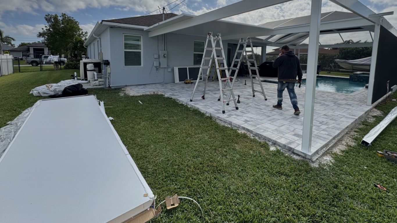 Professional rescreening services for a backyard pool enclosure in progress.