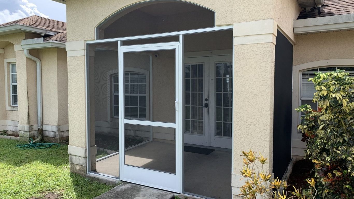 Screened front porch enclosure installed at a home entrance highlighting front entryway screening services.