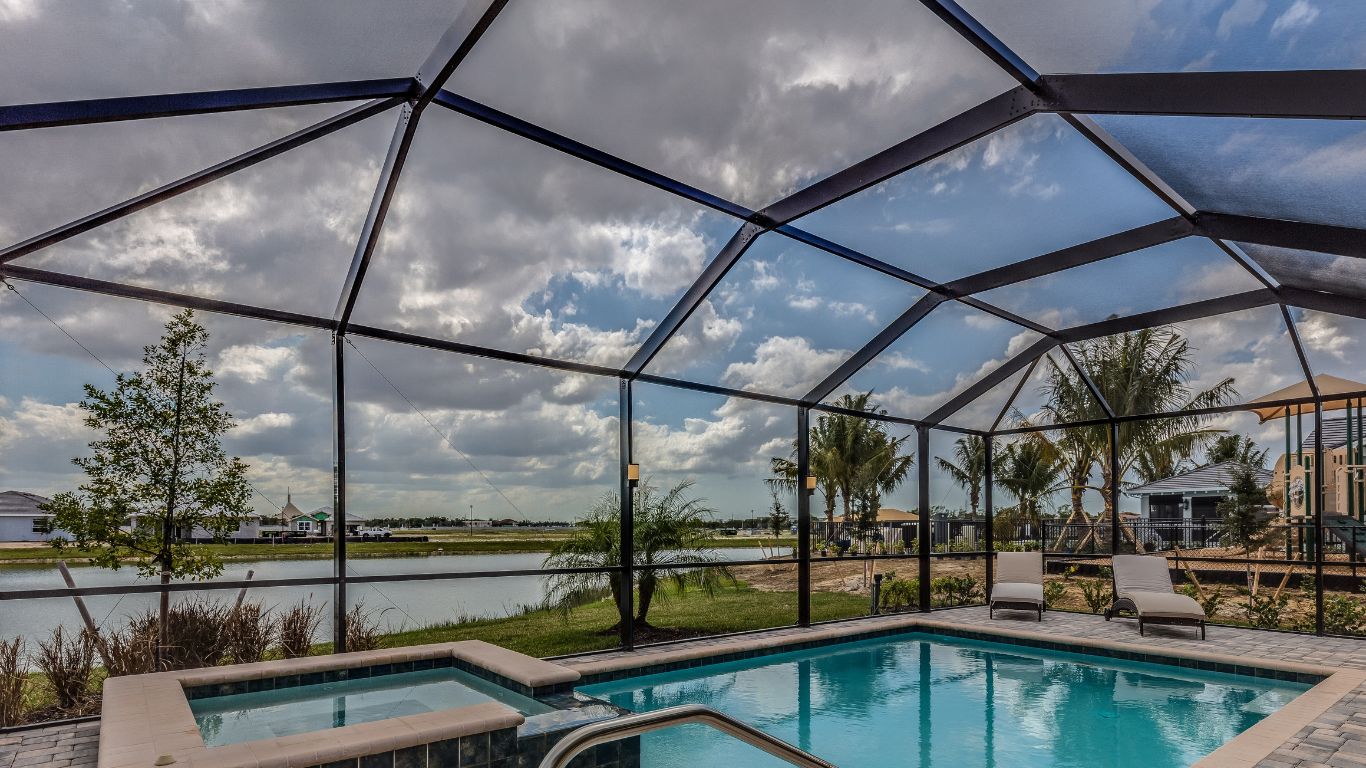 Outdoor pool with a screened enclosure in Fort Myers, FL, showcasing the benefits of pool enclosure.